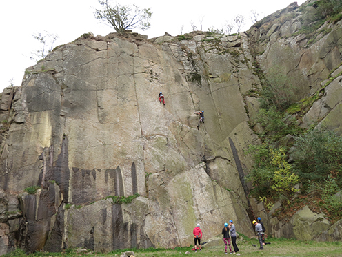 People climing a rock